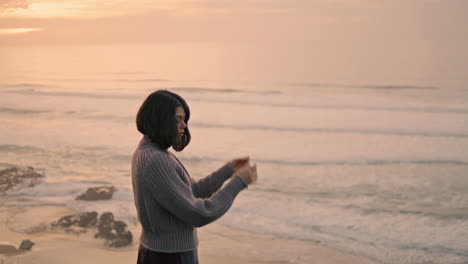 melancholy girl looking ocean waves standing alone on seashore autumn evening.