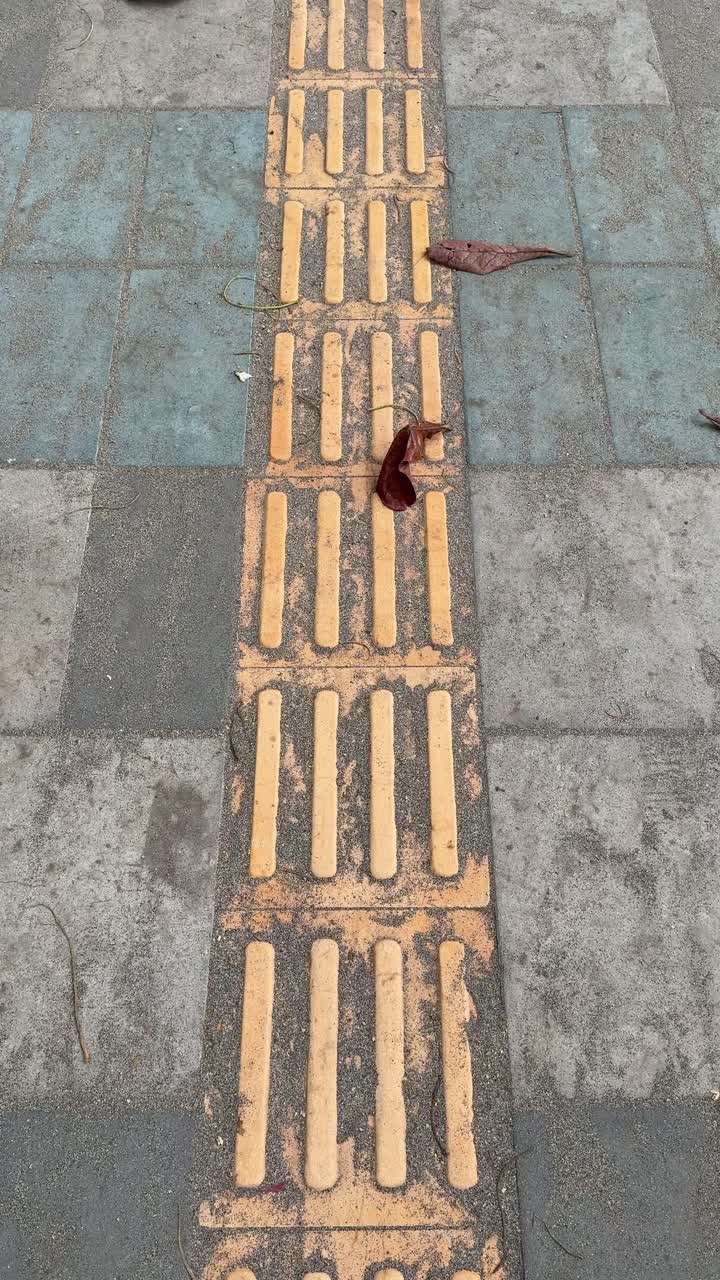 Close-Up View of Yellow Tactile Paving on a Sidewalk