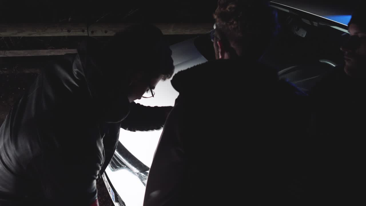 Police officers arresting a suspect at night. Crime, law enforcement, investigation concept.