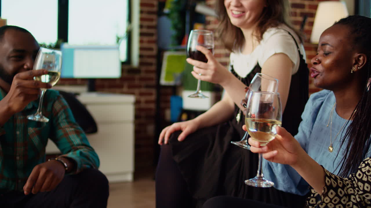 Diverse friends clinking wine and champagne glasses, toasting for their friendship