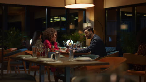 elegant couple sitting restaurant at evening. mixed race lovers dating in cafe.