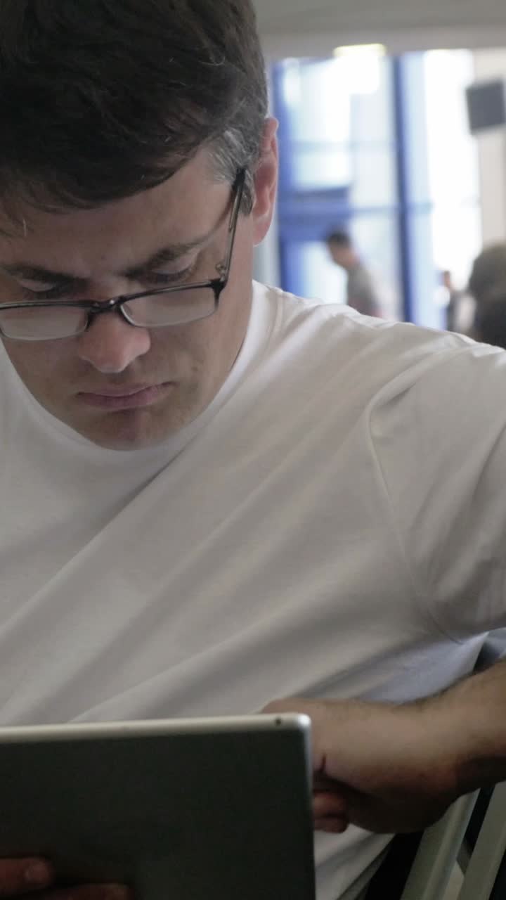 Man using tablet at airport