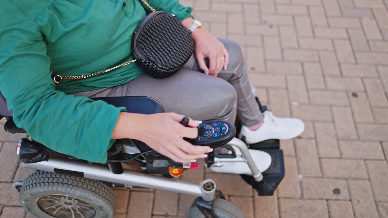Woman Operating Electric Wheelchair Joystick Outdoors