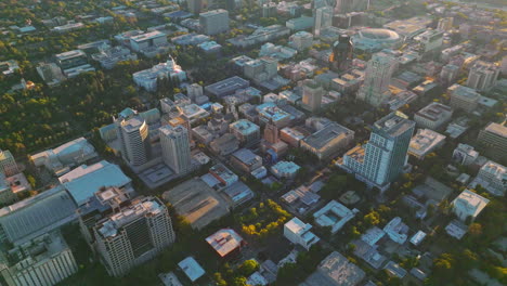 sacramento city architecture full of greenery from aerial perspective. drone footage over the city at sunset.