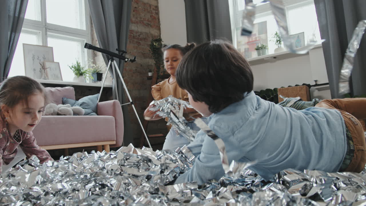 Excited Children Throwing Silver Streamers