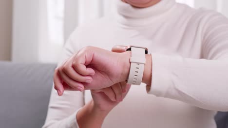 close up shot of a woman hand who touch and scrolling on a smartwatch in order to quickly check application connect