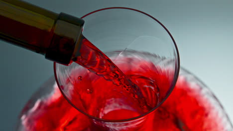 corriente de vino rojo vertiendo vidrio desde el cuello de la botella. decanter de llenado de bebida de rosas