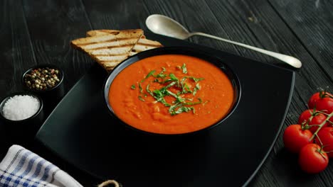 tomato soup in bowl with crisp bread