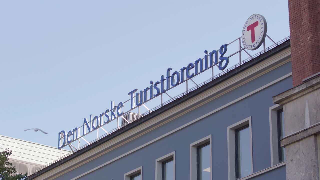 Den Norske Turistforening rooftop signage on Youngstorget, Oslo. Telephoto view
