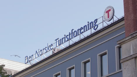 den norske turistforening rooftop signage on youngstorget, oslo. telephoto view