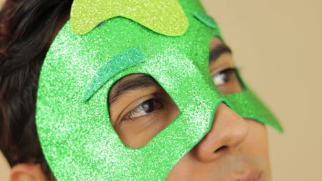 portrait of guy looking at camera wearing pj cartoon foamy mask