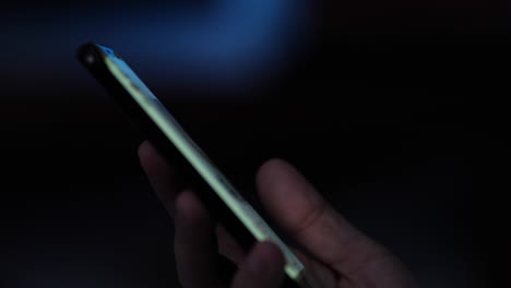 Woman hand using smartphone with lights bokeh.