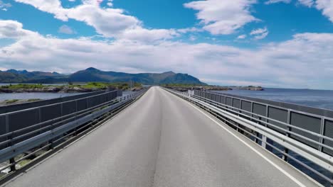 driving a car on a road in norway atlantic ocean road or the atlantic road (atlanterhavsveien) been awarded the title as (norwegian construction of the century).