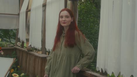 woman in a green dress in a greenhouse