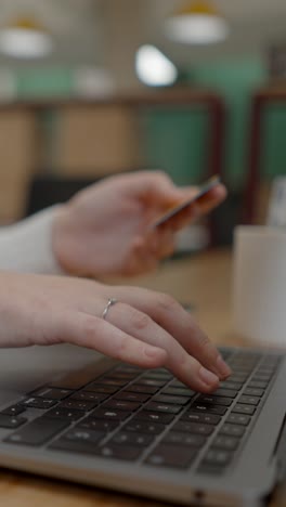 person making an online purchase with a credit card on a laptop