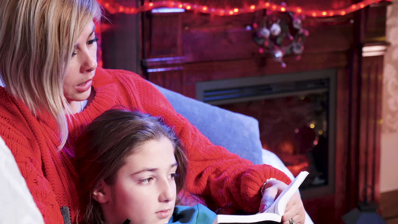 Mother and Daughter Reading by the Fireplace