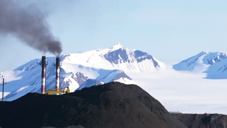 a powerful contrast of a coal power plant in front of a white glacier in barentsburg, svalbard in the arctic