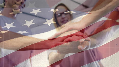 animation of american flag over happy caucasian male and female friends stacking hands