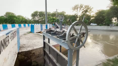 water spillway valve wheel to lift dam on indus river in hyderabad, sindh