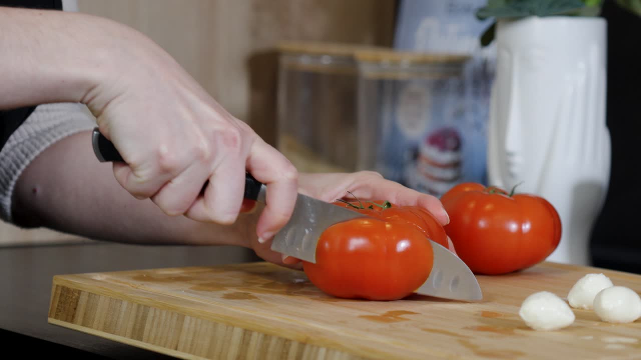 slowmoion of a chef preparing fresh tomato slices ready for a dish