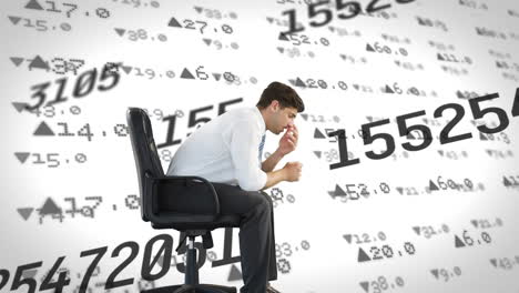 stressed businessperson sits amid fluctuating stock data, symbolizing global finance.