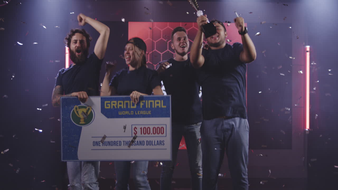 Gaming Tournament Team Celebrating their Victory Medium Shot of a Gaming Tournament Team Holding their Prize while Celebrating their Victory