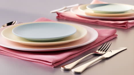 elegant table setting with pastel plates and cutlery