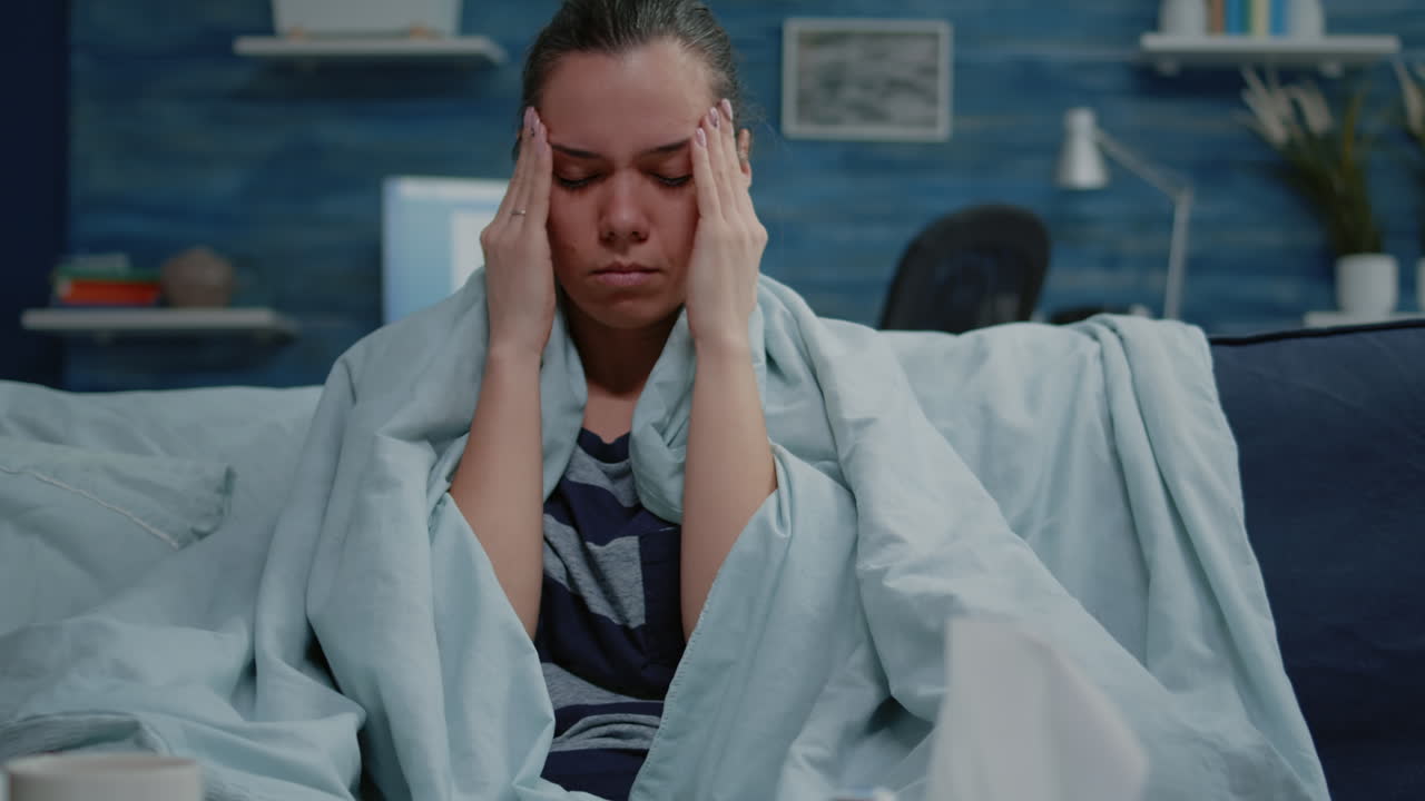 Close up of sick person rubbing temples to cure headache