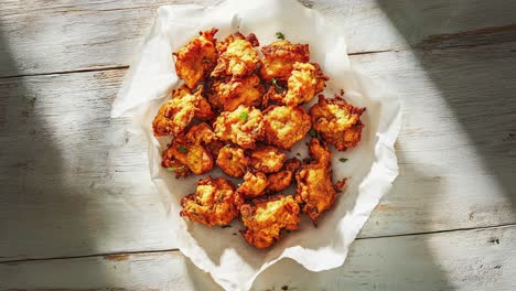 delicious crispy pakoras on rustic white wooden table