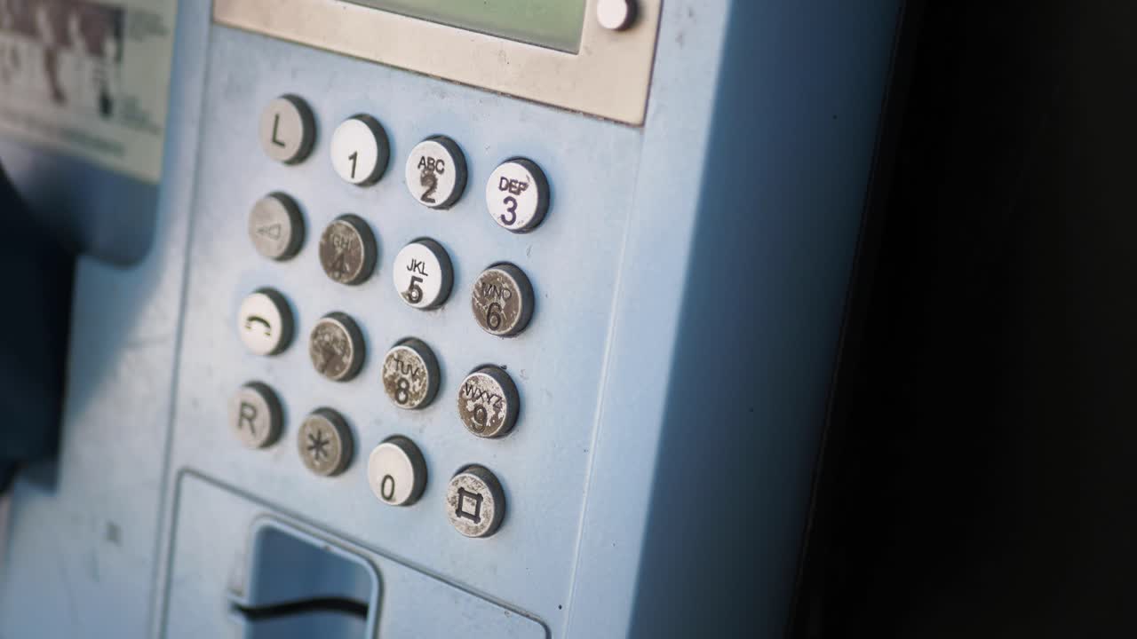 Close-up of an old payphone keypad
