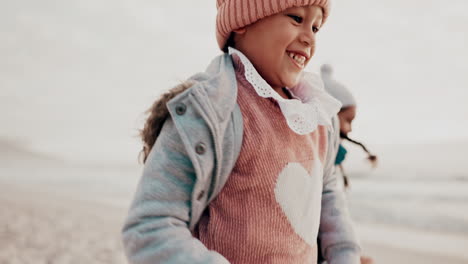 family, sister and children running on the beach