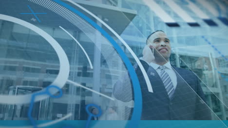 animation of interface with data processing over biracial man talking on smartphone outside office