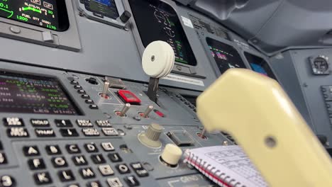 Close-up-view-of-a-pilot-selecting-the-landing-gear-lever-up-after-a-real-time-take-off-just-after-departure