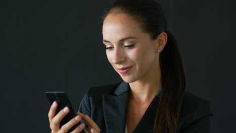 businesswoman with brown hair using smartphone