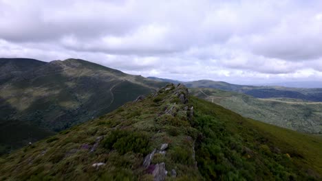 Aerial-drone-footage-following-a-rocky-peak-trail-in-a-beautiful-mountain-range