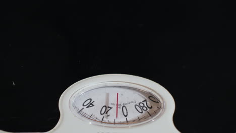 man weighs himself on floor scales 04