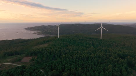 landscape with wind turbines near the sea in camarinas, spain - aerial drone shot