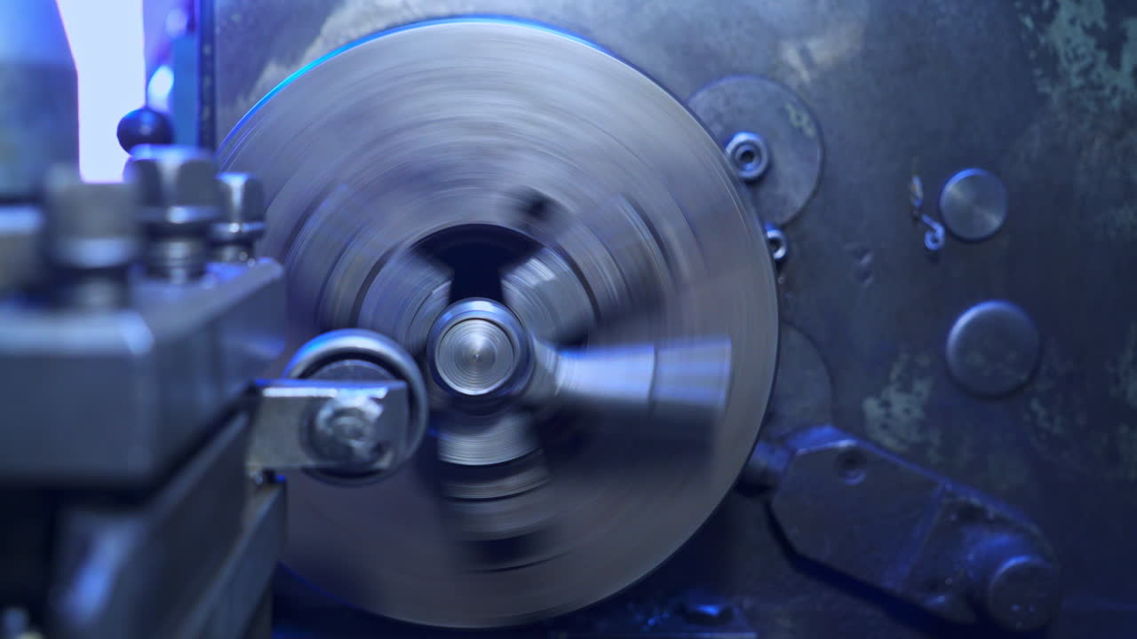 Round rotating detail in turning lathe. Elements on a metal lathe machine. Turner's workshop close up.