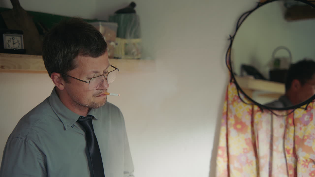 Man Smoking in Small Room