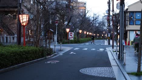 street lights illuminate as dusk falls over city