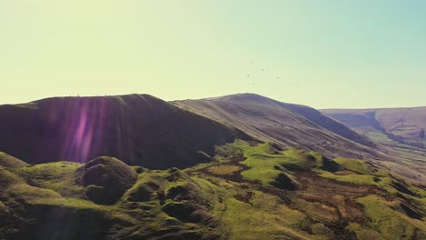 beautiful sunset over mam tor, peak district uk, aerial rise up shot