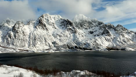 birdseye view of lofoten mountains with snow facing fjord