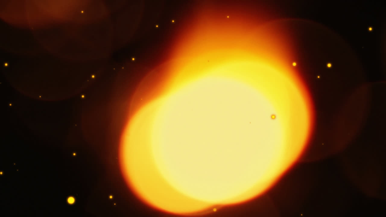 黒い背景に落ちる光の点と金色の点のアニメーション