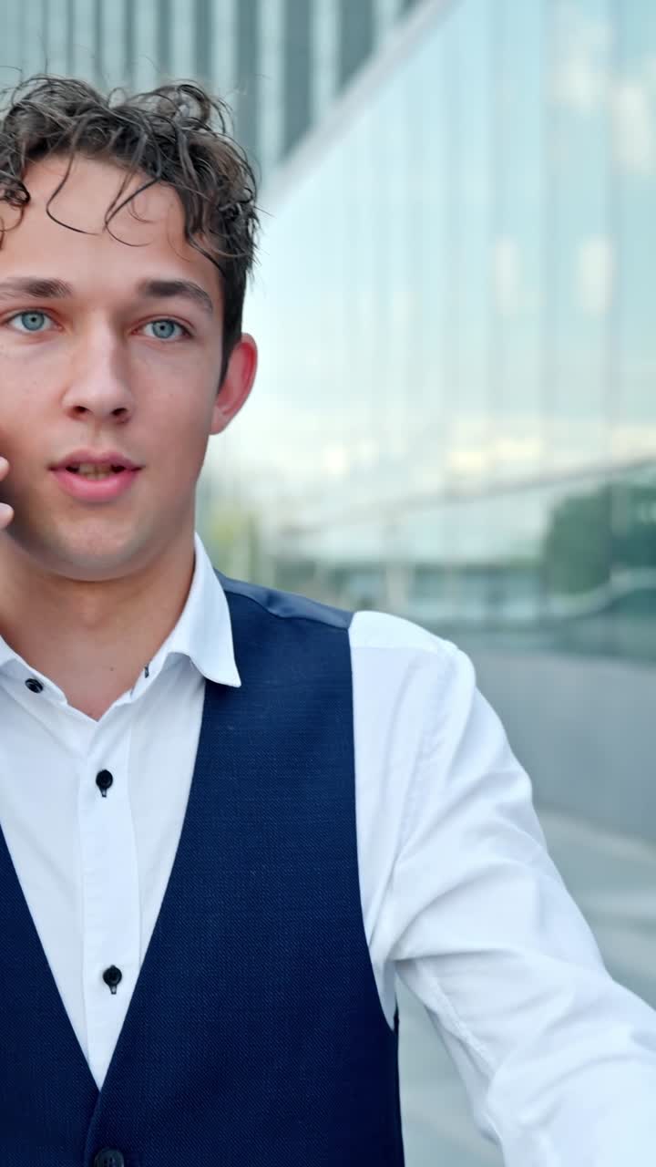Slow motion of young businessman answering angry phone outdoors in city