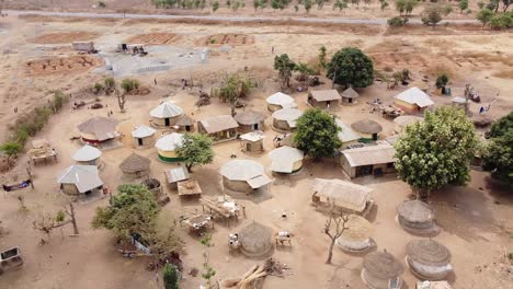 Aerial---a-village-in-Sub-Saharan-Africa,-wide-circle-shot-rising