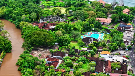Dirty river and small village near coastline of Indonesia, aerial view
