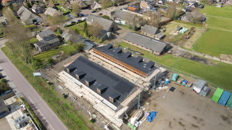 cinematic aerial of solar panels on rooftop of newly constructed homes