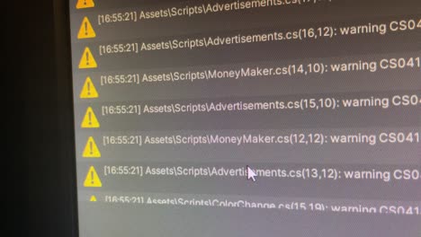 close up of monitor displaying errors and warnings in unity game engine for programming and coding - errors in script in different program files for code