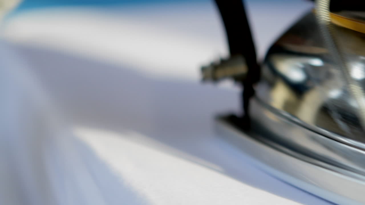 Close up of ironing a white shirt