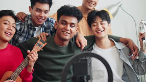 Happy Young Multiracial Friends Hugging Each Other While Singing Together On Live Streaming